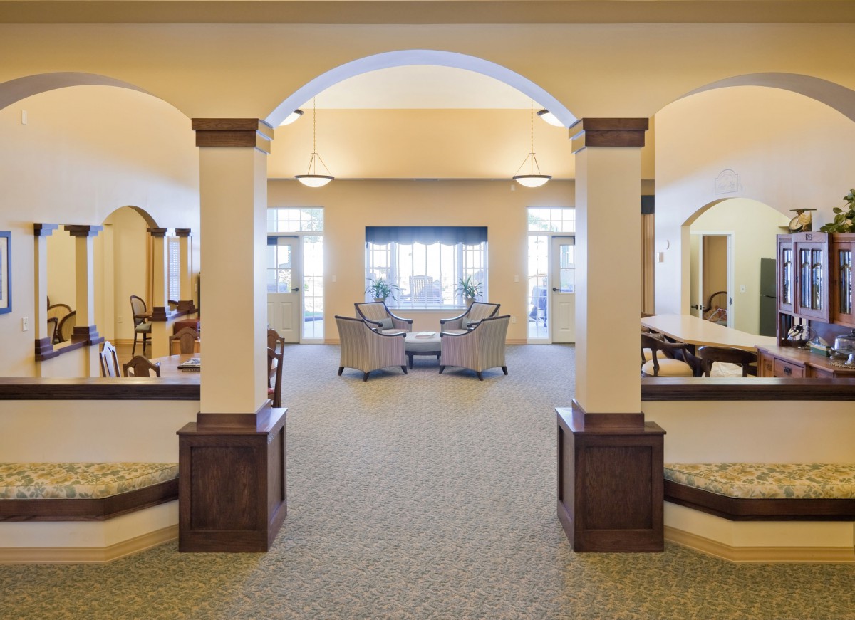A spacious lobby with elegant archways and a cozy seating area.