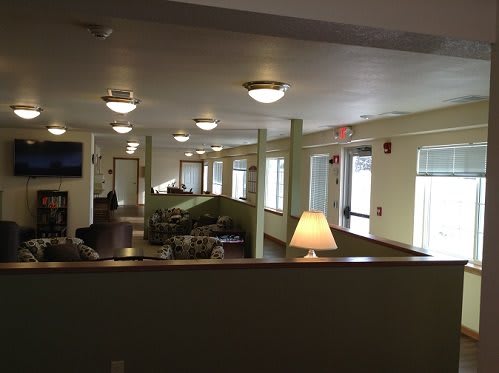 A well-lit interior space with seating areas and large windows.