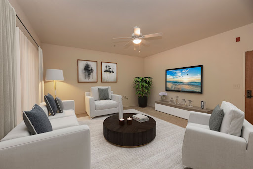 A cozy and modern living room featuring comfortable white furniture and a sleek television setup.