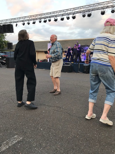 Seniors enjoying a lively outdoor dance event.