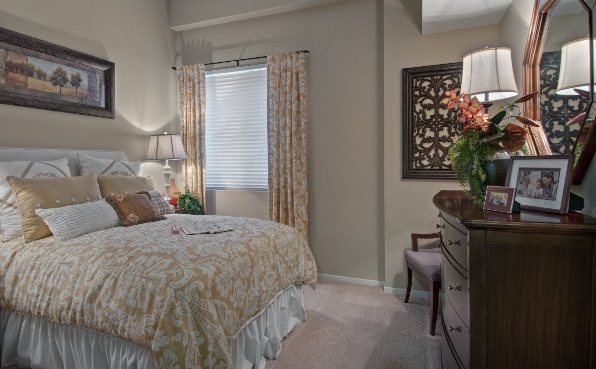 A cozy bedroom with elegant furnishings and decorative touches.