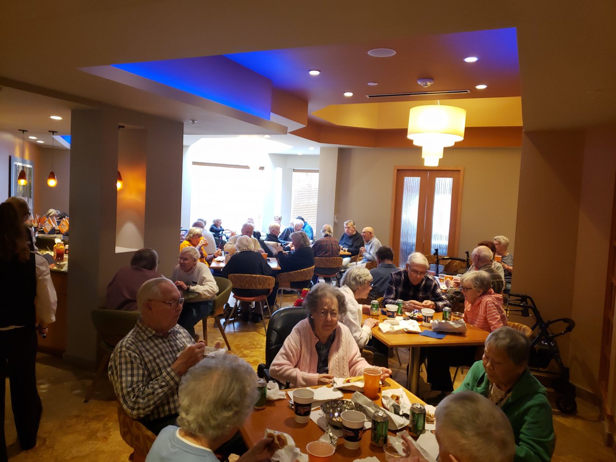 A group of seniors enjoying a meal together in a restaurant.