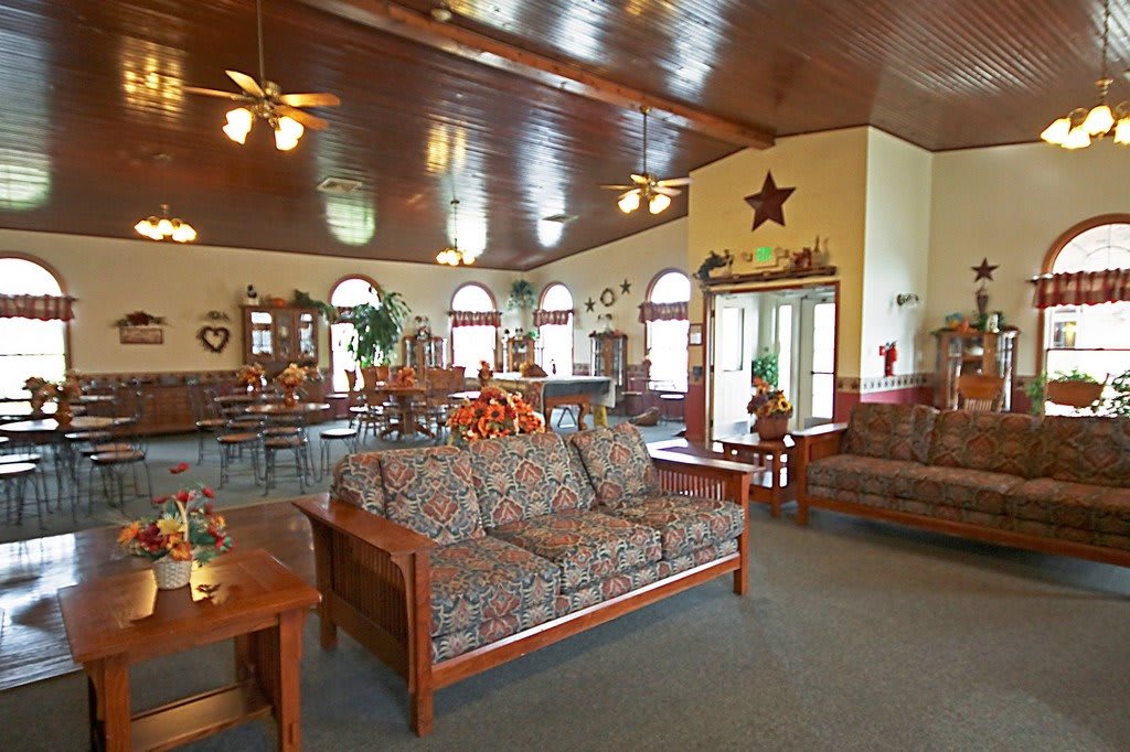 A cozy living room with warm furnishings and a wooden ceiling.