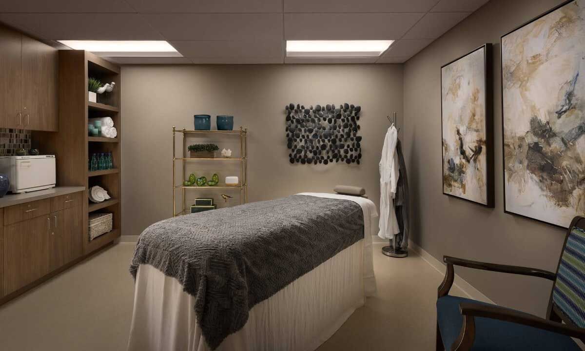 A serene spa massage room with a comfortable bed and soothing decor.
