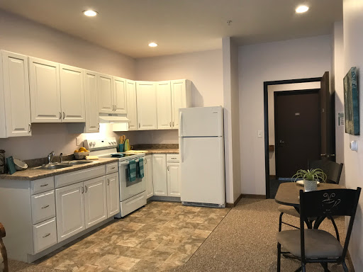 A well-lit kitchen featuring modern appliances and a dining area.