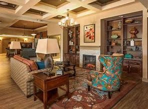 A cozy living room with a colorful armchair, fireplace, and elegant decor.