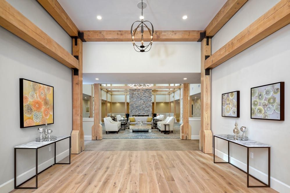 A modern living room with wooden beam accents and contemporary furnishings.