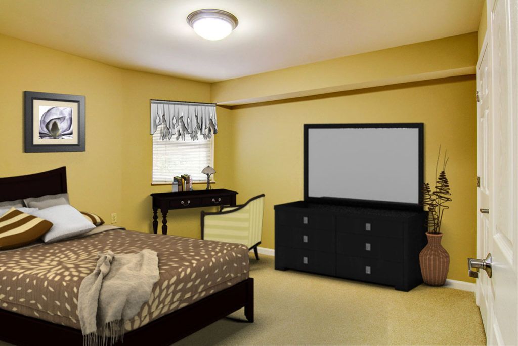 A cozy bedroom with a bed, dresser, mirror, and window.