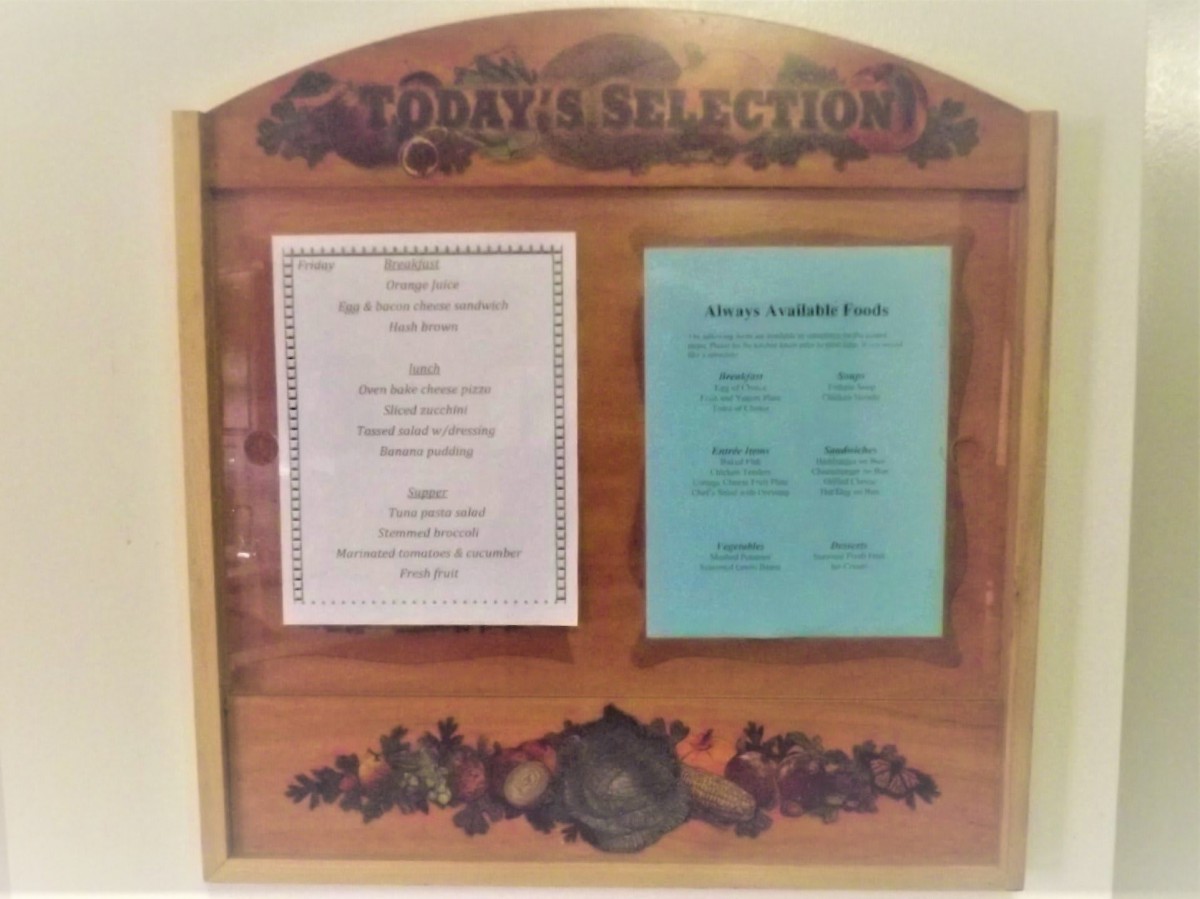 A restaurant's wine and menu options displayed on a wooden board.