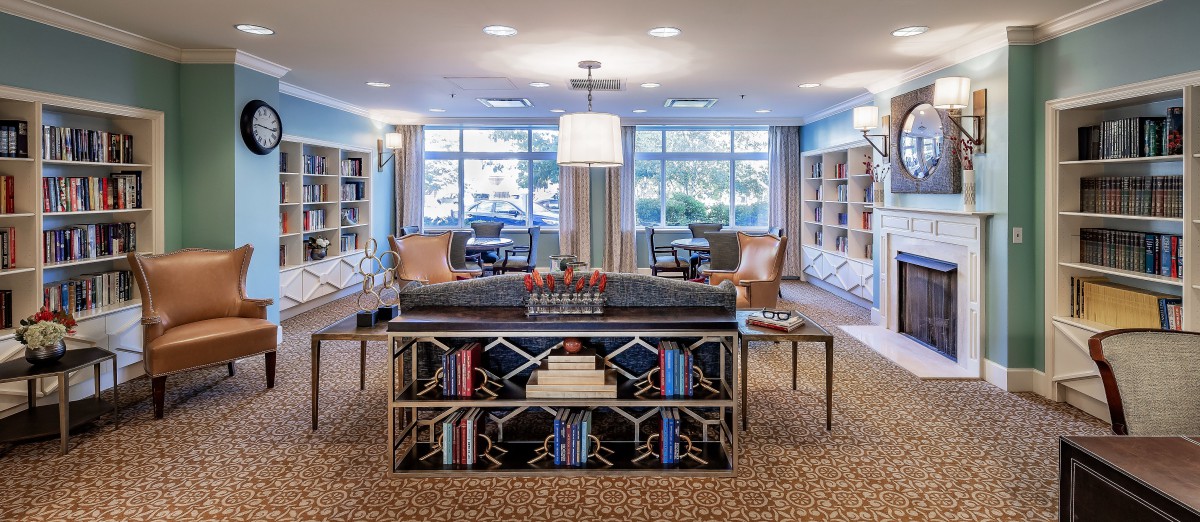 A cozy library interior with bookshelves and comfortable seating.