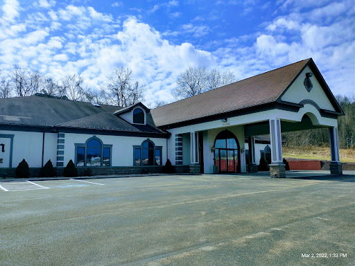A picturesque view of a charming commercial building under a partly cloudy sky.