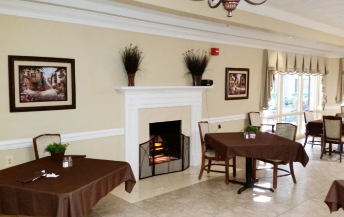 A cozy room with a fireplace and neatly arranged furniture.