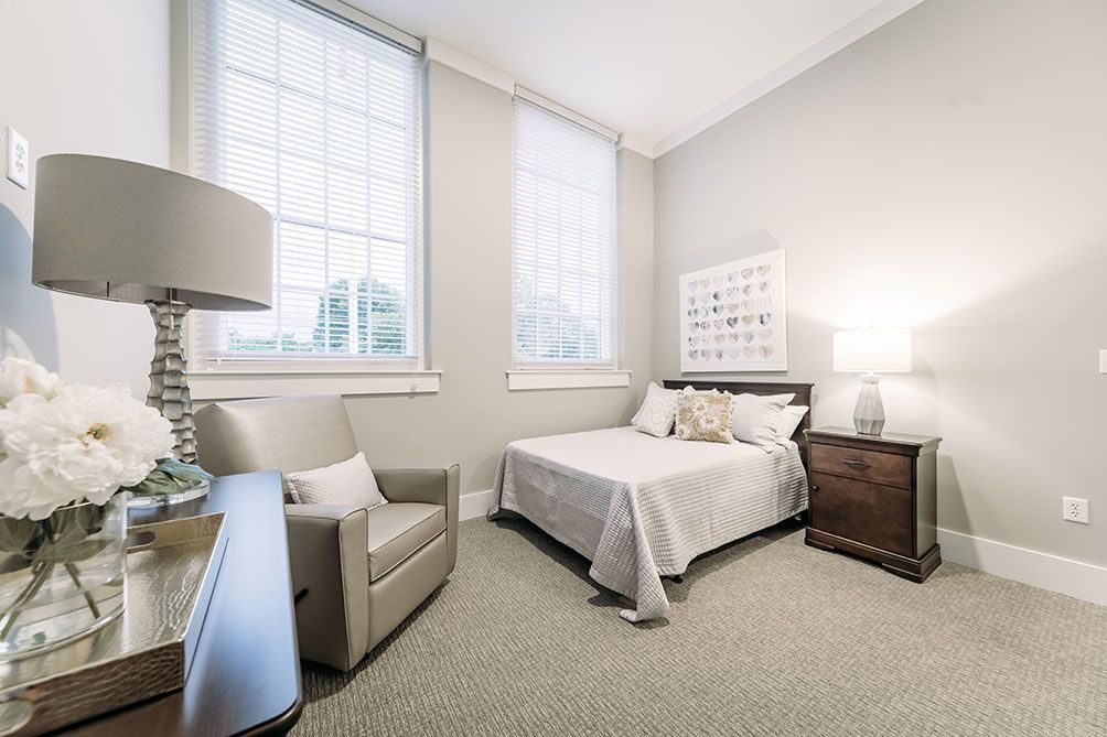 A modern minimalist bedroom with neutral colors and simple decor.
