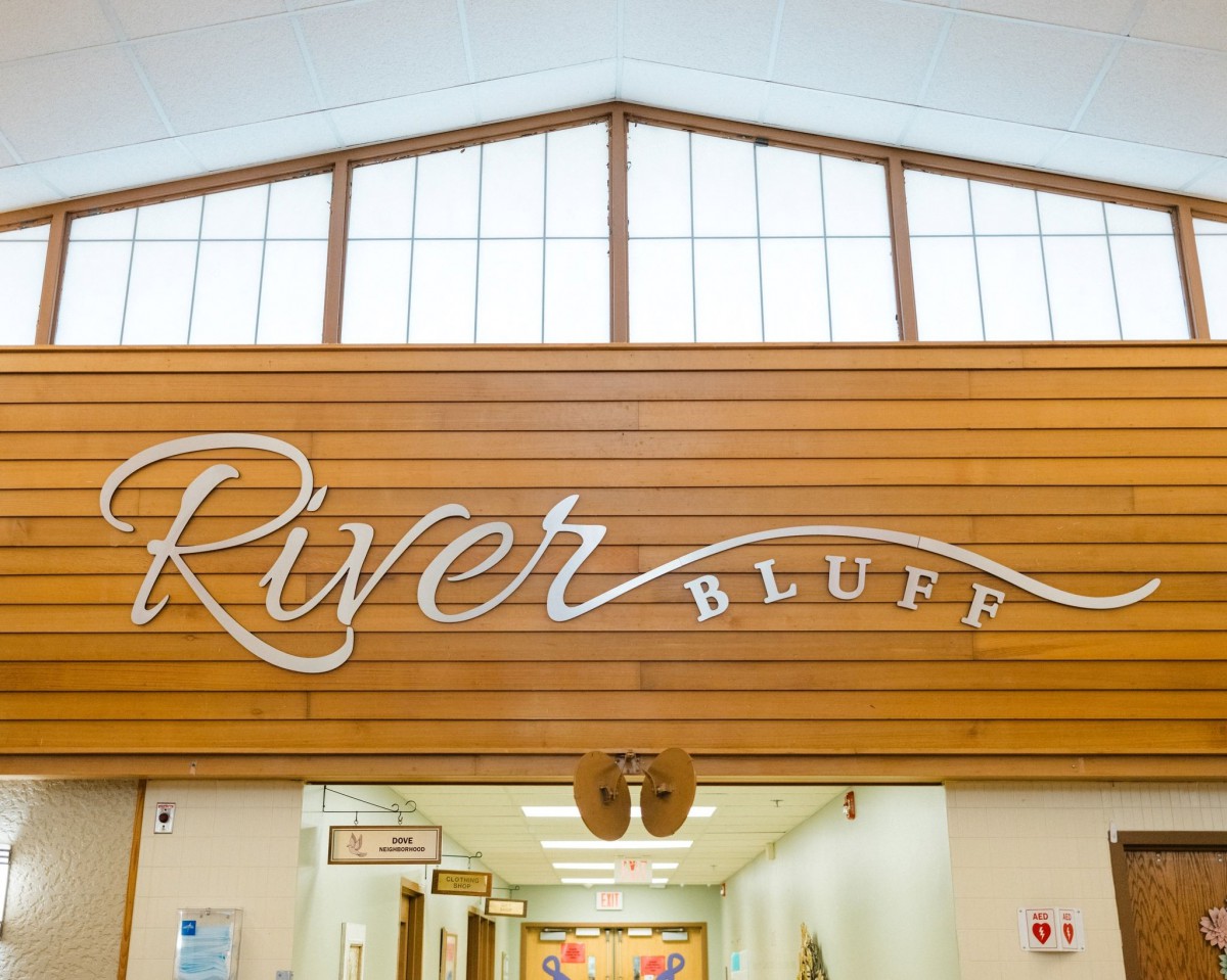Entrance to River Bluff, featuring wood paneling and signage.