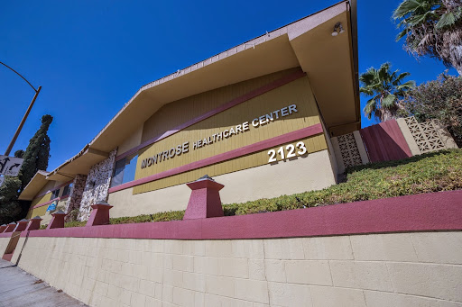 Exterior view of a medical center with signage displaying the address and name.
