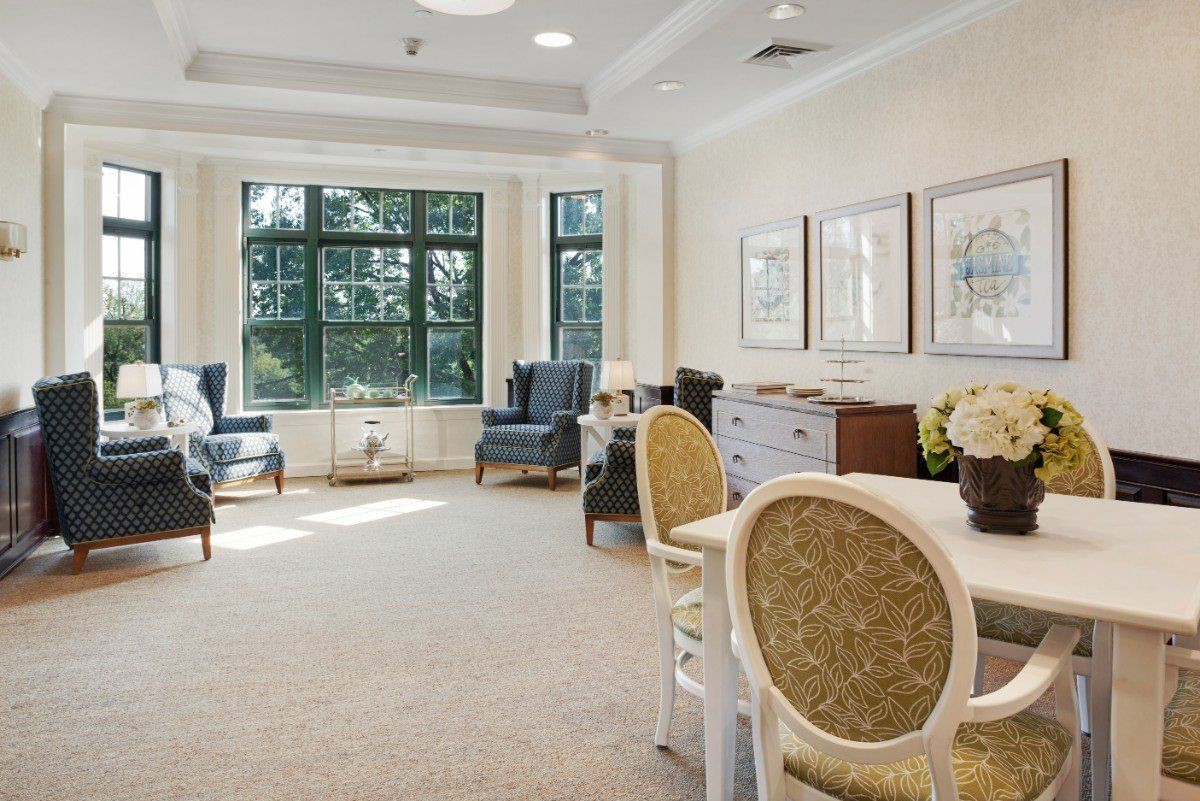 A bright and spacious living room with elegant furniture and large windows.