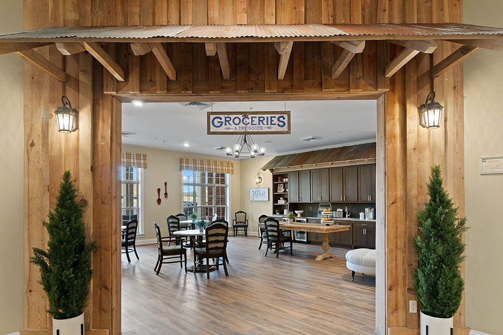 A cozy grocery store interior with a rustic wooden entrance and seating area.