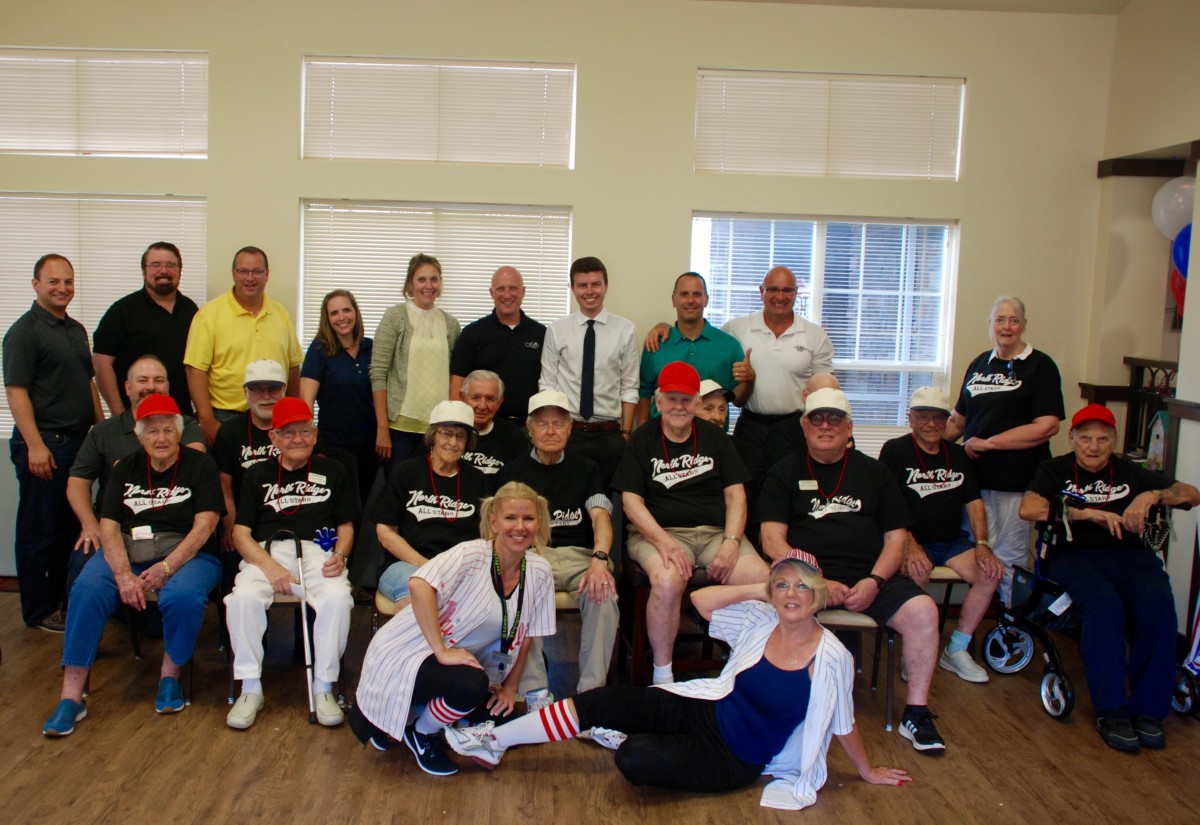 A group of people in casual attire gathered indoors for an event.