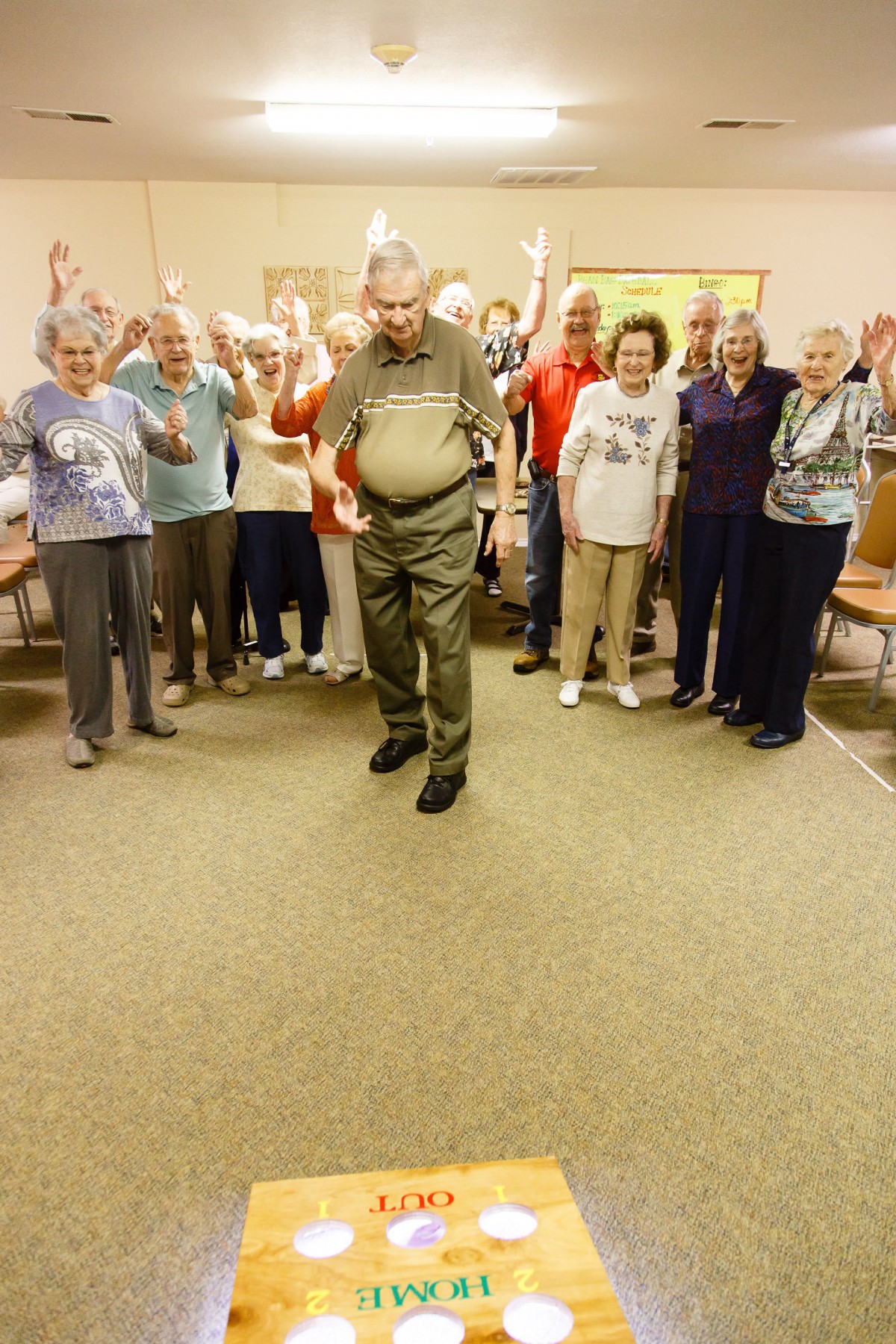 A group of seniors gathered indoors, participating in a community activity.