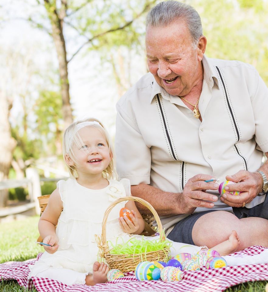 A grandparent and child enjoying a picnic together in the park.