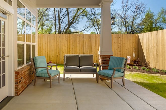 A cozy patio with outdoor furniture on a sunny day.