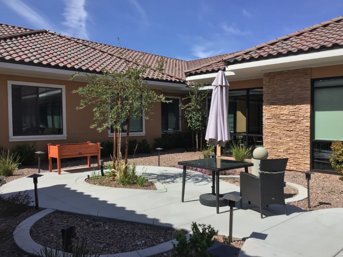 A cozy patio area with outdoor seating and a garden.
