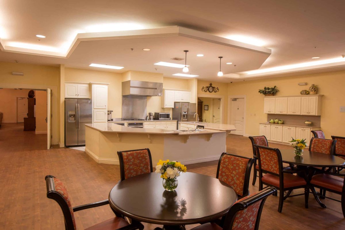 A modern kitchen and dining area with elegant lighting and contemporary furnishings.