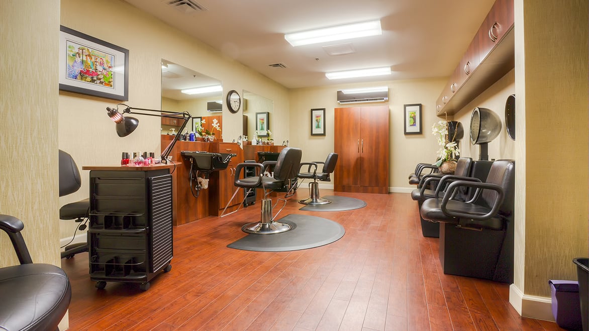 Interior of a modern hair salon with styling chairs and mirrors.