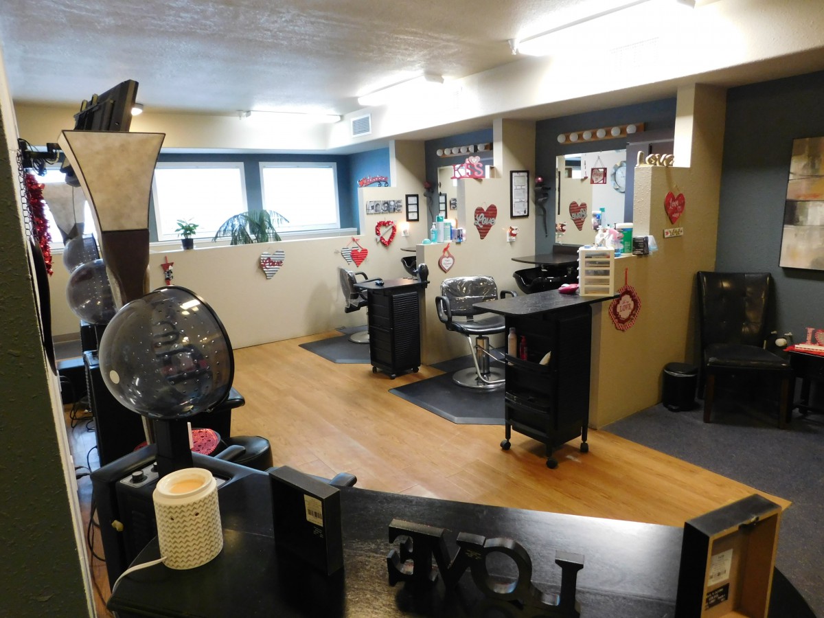 A cozy hair salon interior decorated with heart-themed decor.