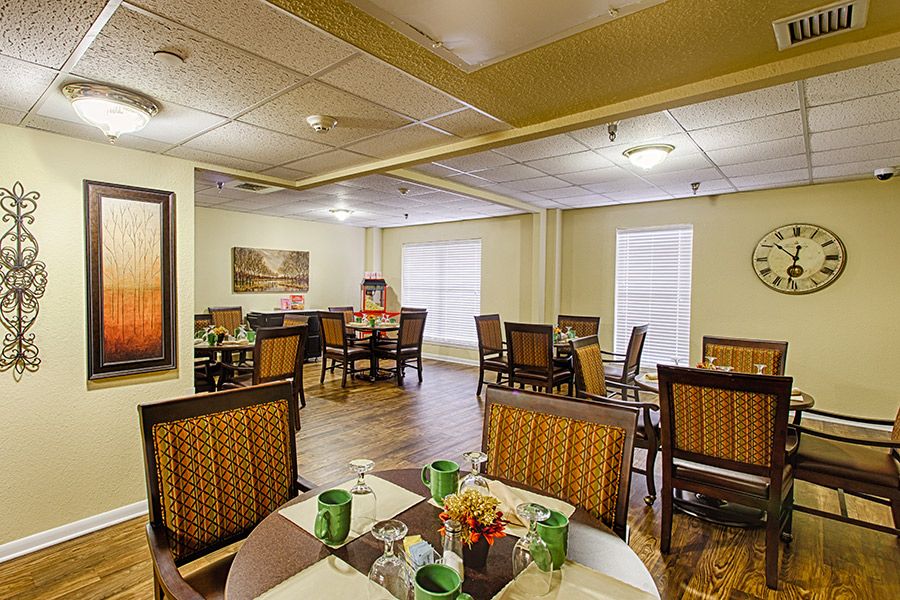 A cozy dining room with elegantly set tables and comfortable seating.