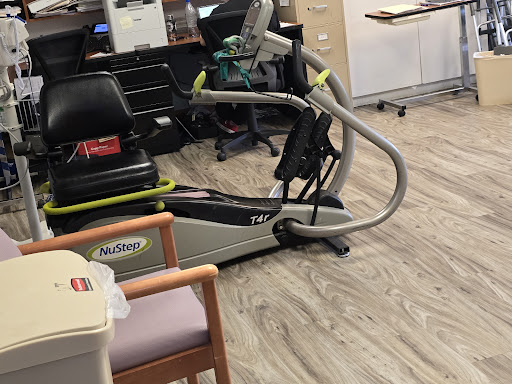 A modern exercise machine designed for rehabilitation and fitness within a healthcare setting.
