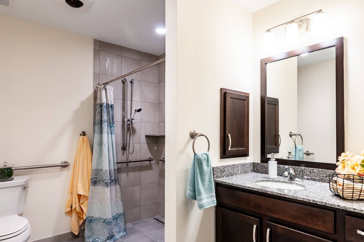 A modern bathroom with a shower and vanity area.
