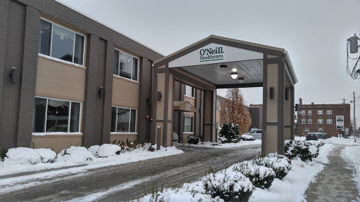 A winter view of a hotel entrance, adorned with snow.