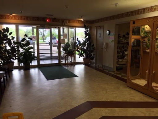 A welcoming lobby entrance featuring plants and a spacious floor area.