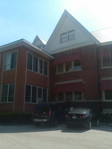A brick building showcasing unique architectural features under a clear sky.