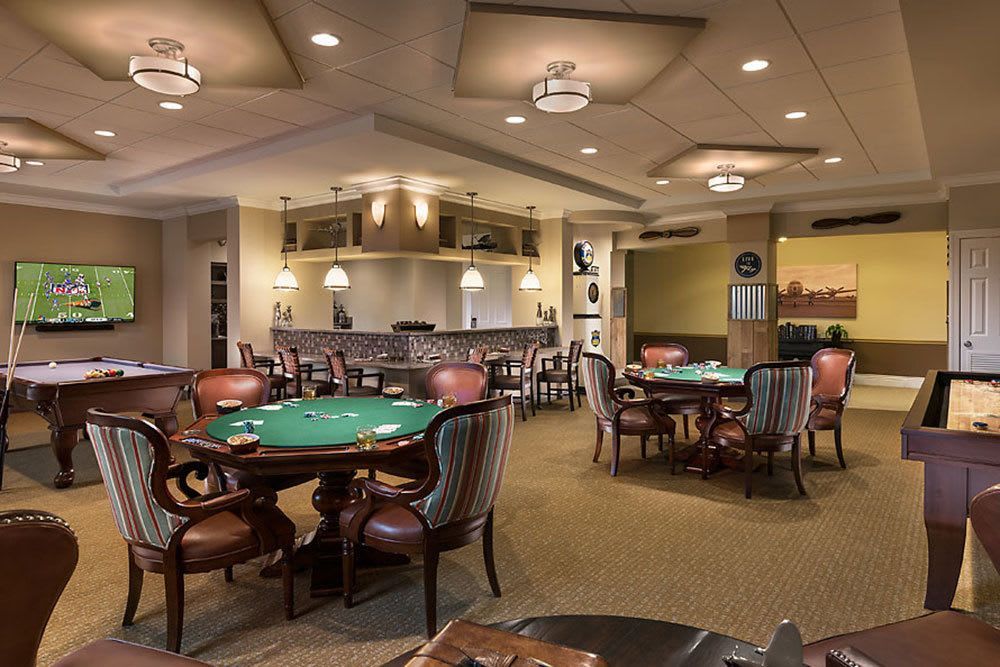 A cozy casino interior with multiple gaming tables and elegant seating.