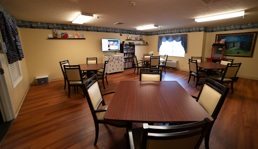 A cozy dining area featuring tables and chairs, designed for community gatherings.