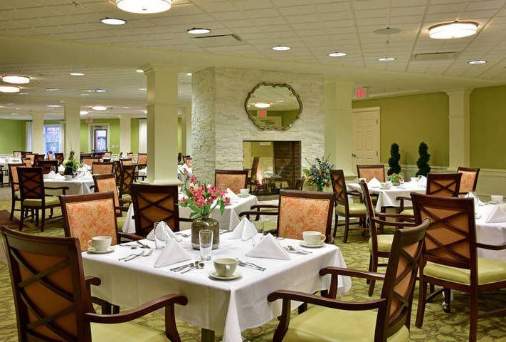 An elegant restaurant dining room with neatly set tables and comfortable chairs.