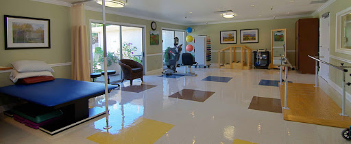 A bright and welcoming lobby area featuring comfortable seating and a clean, colorful floor.