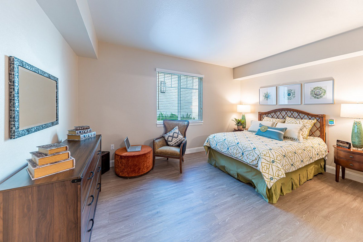 A cozy and modern bedroom with elegant decor and natural lighting.