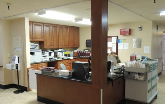 An office reception area with desks and equipment.