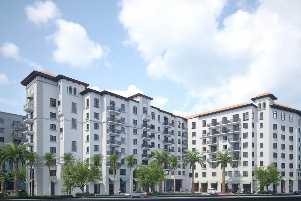 Modern apartment complex with palm trees in an urban setting.