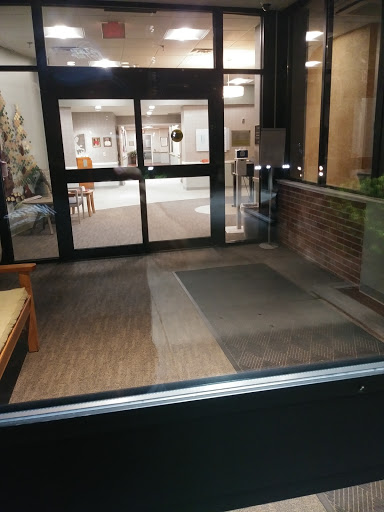 A view of the entrance lobby with seating, showcasing the interior design and flooring.