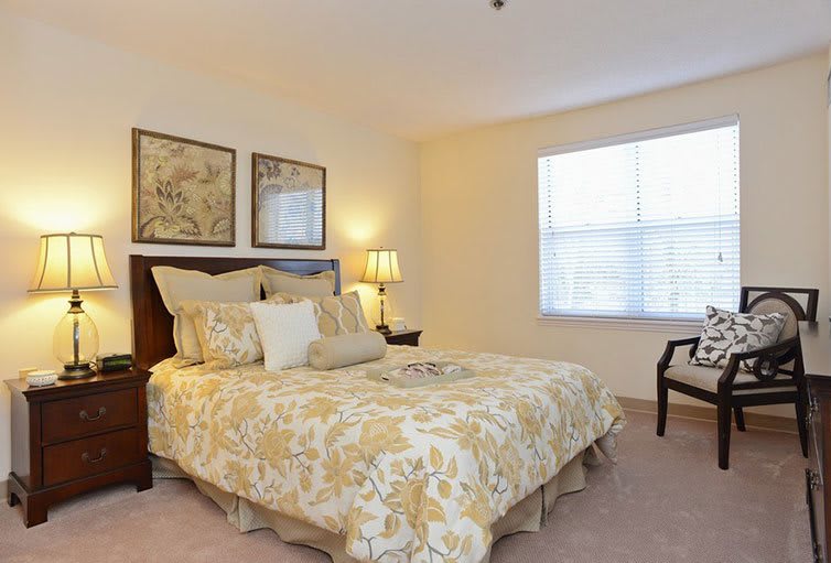 A cozy bedroom with elegant decor and warm lighting.