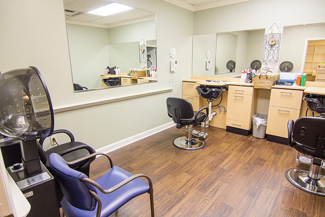 An empty hair salon with chairs and mirrors, ready for clients.