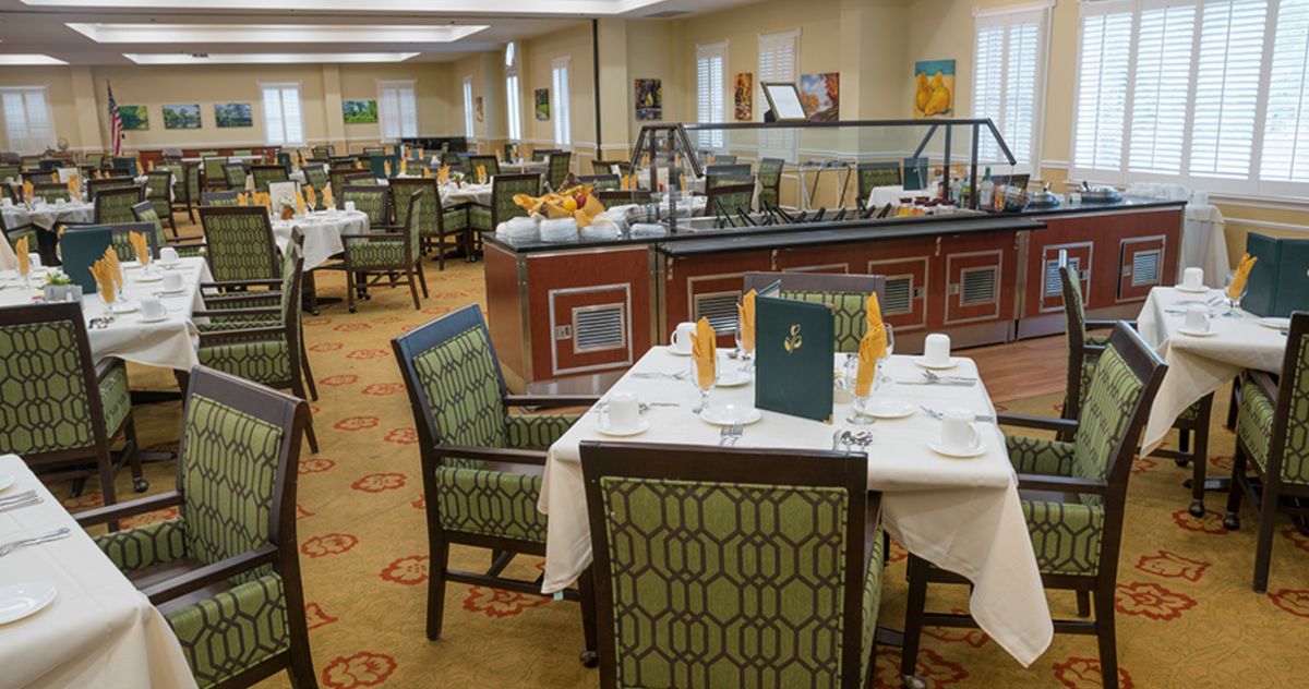 An elegant dining area with neatly arranged tables and a buffet section.