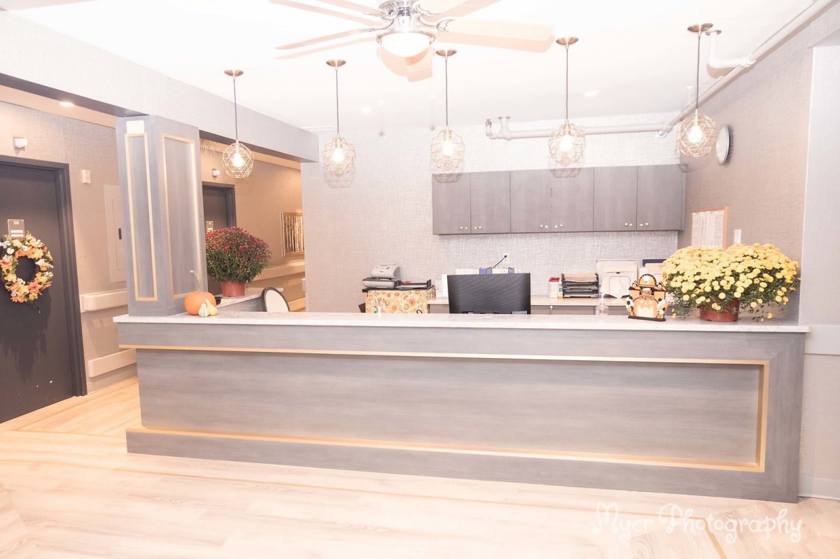 A modern reception area featuring stylish lighting and a sleek counter design.