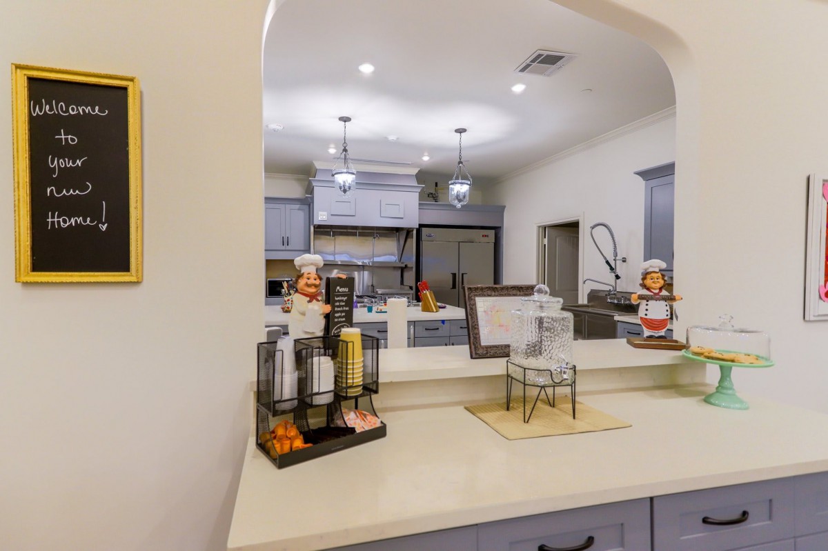 A modern kitchen interior featuring a coffee station on the countertop.