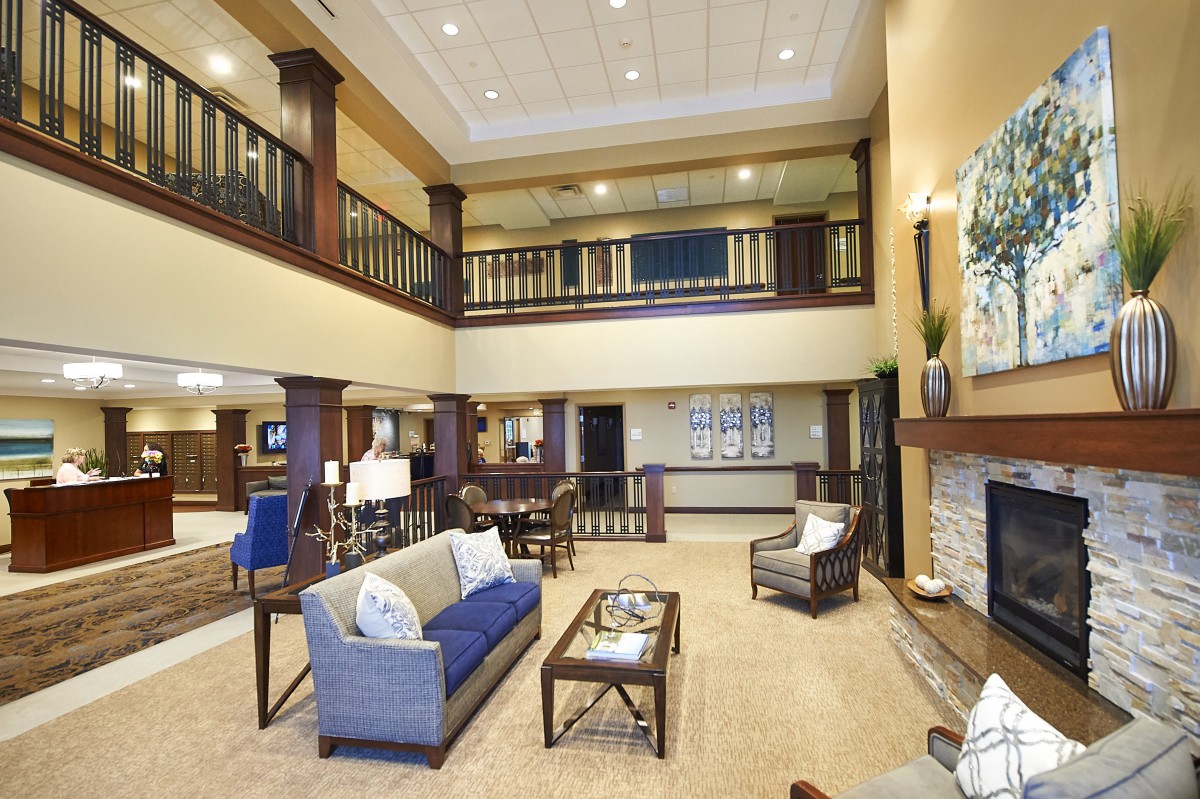A modern and spacious hotel lobby with comfortable seating and a two-story design.