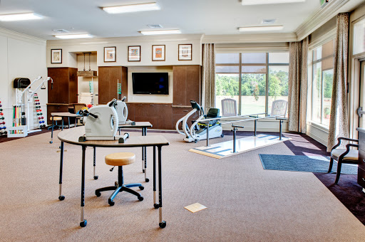 A well-equipped rehabilitation gym featuring exercise machines and a spacious layout.